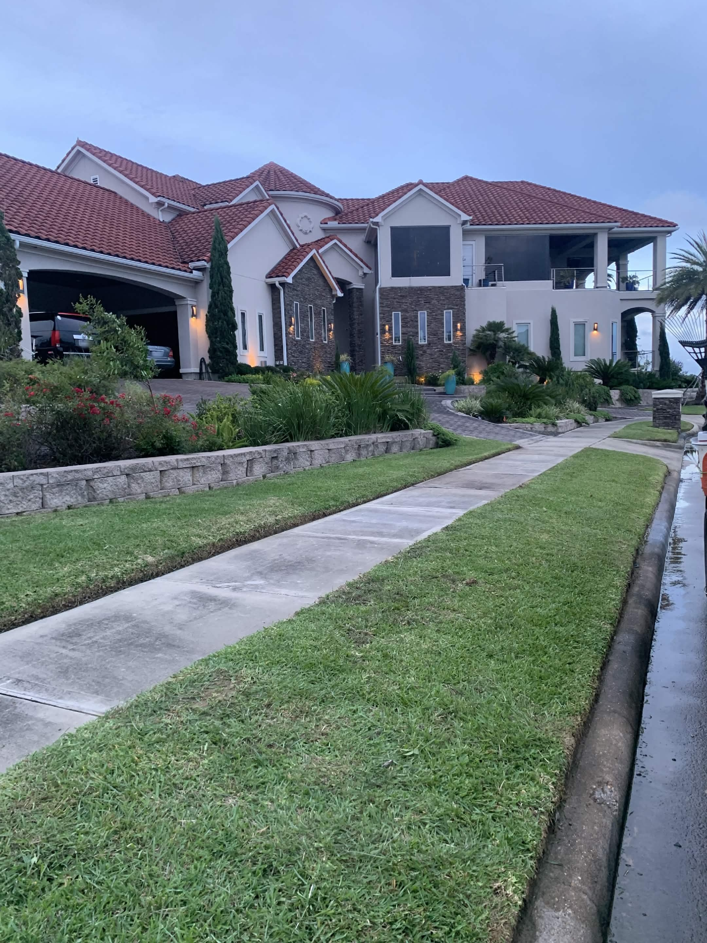 Clean residential front lawn and landscaped property maintained by Saints Lawn Maintenance